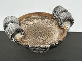 a black and white bowl with two birds on it