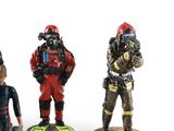three figurines of people wearing diving gear and diving gear