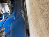 a blue air compressor sitting on top of a blue car