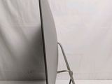 a computer monitor sitting on a stand with a cord
