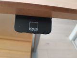 a remote control sitting on top of a wooden table