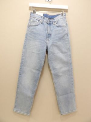 the jeans are hanging on a hanger on the wall