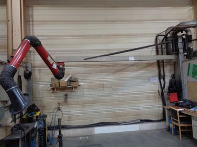 a robot that is attached to a wall in a garage