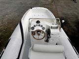 a white boat with a steering wheel and a steering wheel on it