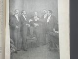 an open book with a picture of a group of men in suits