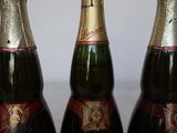 three bottles of champagne are lined up on a table