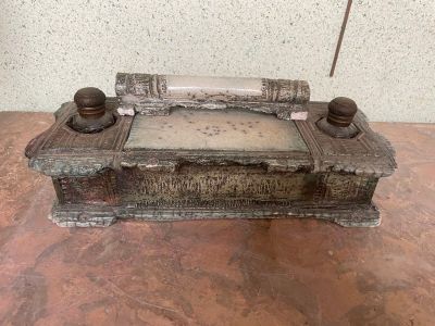 a wooden box with a glass bottle on it