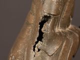 an old statue of a woman with a broken arm