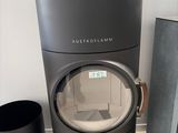 a black stove sitting next to a black trash can