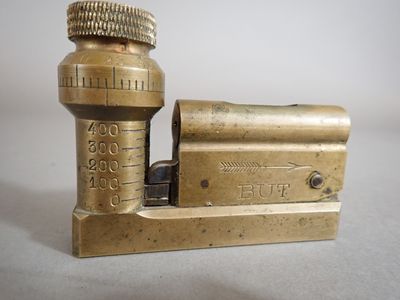 an old brass lighter sitting on top of a white table