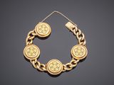 a gold bracelet with four medallions on a chain