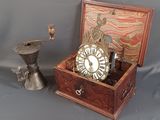 a small wooden box with a clock inside of it