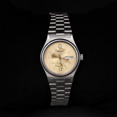a watch that is sitting on a black surface