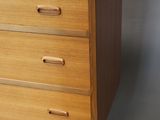 an image of a wooden chest of drawers with a plugged outlet