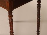 a small wooden table with a drawer on top of it