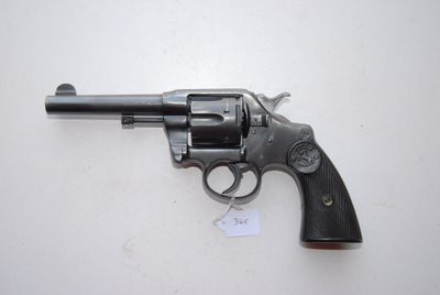a close up of a revolver on a table with a tag on it