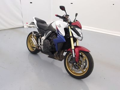 a red, white and blue motorcycle parked in a room