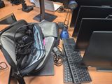 a bag that is sitting on a desk with a keyboard and monitor