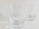 four glasses that are sitting on a table