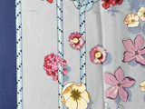 a close up of a table cloth with flowers on it