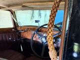 a rope hanging from the back of an old car