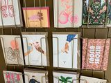 many greeting cards on a rack on the wall