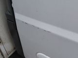 a close up of a white van door with a handle on it