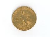a gold coin with a bird on it on a white surface
