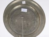 a silver plate on a clear stand with a sticker on it