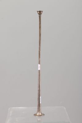 an antique silver plated candle holder on a clear glass stand
