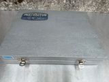 a metal case with a blue sticker on it