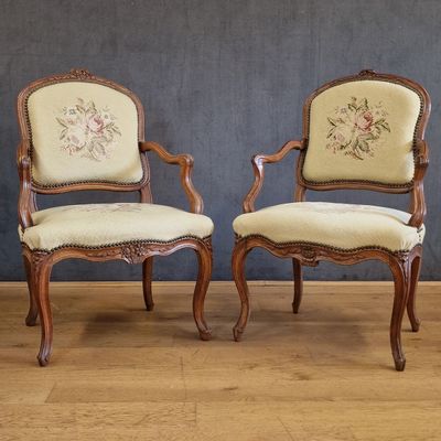 pair of antique chairs with floral upholstered upholstered cushions