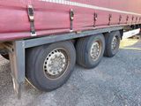 a red semi truck that is parked on the side of the road