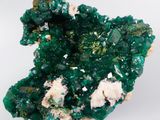 macro shot of a cluster of green and white crystals on a white surface
