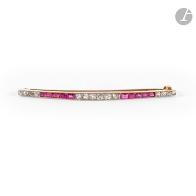 a close up of a pink and white diamond bar broochle