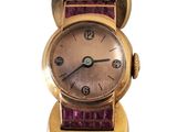 an image of a close up of a wrist watch with a purple strap