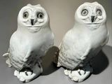 two white owl figurines sitting on top of each other