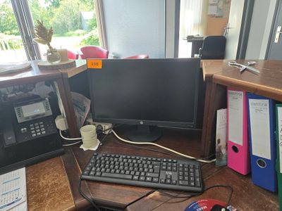 a computer desk with a keyboard, mouse, and monitor on it
