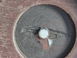 a close up of a metal object with a hole in it