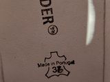 a close up of a pair of shoes with a label on them