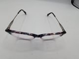 pair of reading glasses on a white surface with a white background
