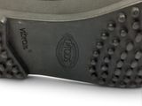 the sole of a pair of black shoes with spikes on them