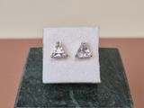 a close up of a pair of earrings sitting on top of a box