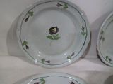 three plates with flowers and leaves on them on a table