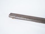 a long metal rod on a white surface