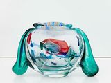 a glass fish bowl with a red fish inside of it