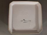 a white plate with a black writing on it