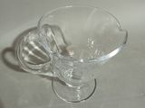 a clear glass cup sitting on a white table