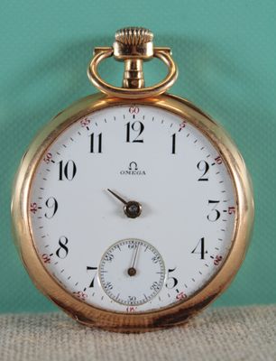 a close up of a gold pocket watch on a table
