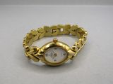 an image of a gold wrist watch on a white surface